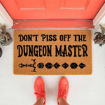 Dungeon Master doormat featuring funny gaming text and polyhedral dice graphics on a natural coir welcome mat, perfect for a tabletop gamer porch decor or a unique housewarming gift for a fantasy roleplaying game fan.