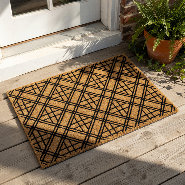 Geometric pattern coir doormat featuring a bold black crisscross design on natural brown fiber, this durable outdoor welcome mat provides a modern look for your front porch entry, patio, or home entryway floor decor.