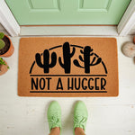 Not A Hugger cactus doormat featuring a funny desert plant design on natural coir fiber, perfect as a humorous front porch welcome mat for home entryways, outdoor decor, or a quirky housewarming gift for plant lovers and