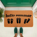 Hello Summer doormat with flip flop icons on natural coir fiber, a seasonal outdoor welcome mat for your front porch decor that features a fun beach theme design for the warm weather months and summer home entryway styling.