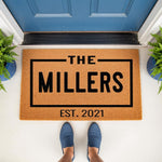 Personalized family name doormat featuring a custom established date, displayed as a natural coir welcome mat on a front porch.