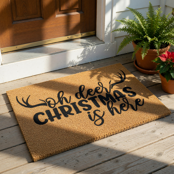 Oh Deer Christmas is Here doormat with black antler design on natural coir fiber, this festive holiday welcome mat is a funny seasonal front porch rug for winter home decor and outdoor entryway floor covering for the holiday