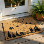 Christmas cabin doormat featuring a flying sleigh and reindeer silhouette on natural coir fiber, this holiday welcome mat adds festive winter decor to your front porch entryway with its charming forest and night sky design.
