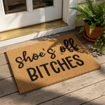 Funny shoe's off BITCHES doormat with bold black text on a natural coir fiber mat, perfect for a sassy front porch entry, housewarming decor, or a humorous welcome mat for your home entrance that keeps floors clean and guests