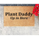 Plant Daddy Up in Here coir doormat for houseplant lovers, featuring a natural fiber welcome mat with black text and a small leaf icon, perfect for a front porch entry or a gardener home decor gift for a plant enthusiast.