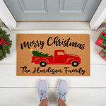 Personalized Merry Christmas doormat featuring a red truck with a tree, this custom family name welcome mat is a durable coir floor rug for holiday porch decor, perfect for seasonal home entryways and festive front door styling.