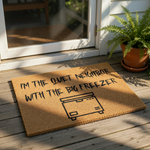 Funny doormat with the text I'm the quiet neighbor with the big freezer and a line art freezer icon, this natural coir welcome mat is a humorous front porch decor piece for your home entrance or a unique housewarming gift idea.
