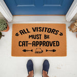 Cat-approved welcome doormat featuring funny pet lover text and fish bone graphics on a natural coir fiber mat, placed at a front door entrance to create a humorous and inviting home decor look for any cat owner or animal lover.