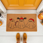 Christmas ghost doormat featuring three cute ghosts wearing holiday hats and accessories on a natural coir welcome mat, perfect for a festive front porch entry decor during the winter holiday season for your home entrance.