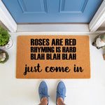 Funny welcome doormat with humorous text about rhyming, featuring a natural coir fiber texture on a front porch.