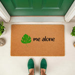 Leave me alone doormat with a green monstera leaf design on natural coir fiber, a funny front porch welcome mat for introverts that adds a humorous touch to your home entryway decor and outdoor floor mat collection.