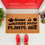 Home is where my plants are coir doormat for plant lovers, featuring a natural fiber welcome mat with black floral typography, placed on a front porch entryway for a gardener or houseplant enthusiast looking for home decor.