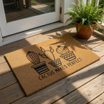 Cactus Makes Perfect doormat featuring three potted desert plants in a minimalist line art style on a natural coir welcome mat, providing a stylish and decorative entryway floor rug for any home or apartment front door decor.