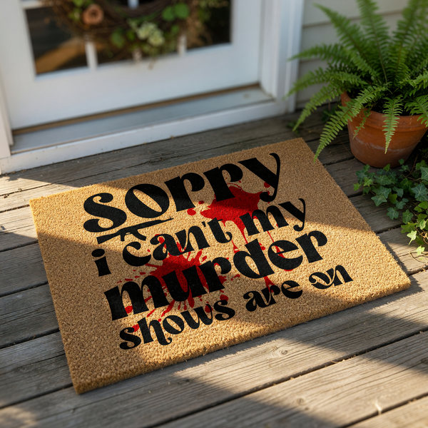 Funny murder show doormat with a natural coir fiber texture, featuring bold black text and a red blood splatter design that reads Sorry I can't my murder shows are on, perfect for true crime fans and unique front porch home decor.