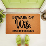 Beware of Wife dog is friendly doormat featuring funny text on a natural coir fiber mat, perfect for a front porch entryway.