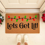 Lets Get Lit Christmas doormat featuring red and green holiday light bulbs on a natural coir welcome mat, perfect for festive front porch decor and funny seasonal entryway floor mats for your home during the winter holiday season.
