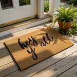 Hey Y'all doormat featuring black cursive script on a natural coir fiber mat, this rustic welcome mat is a durable outdoor floor rug for your front porch entry that adds a charming southern touch to your home decor and entryway.