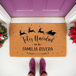 Personalized Feliz Navidad family doormat featuring a Santa sleigh and reindeer silhouette on natural coir fiber, perfect for a festive holiday front porch decor entrance mat that welcomes guests to your home for the winter