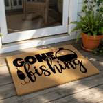 Gone Fishing coir doormat featuring a black printed fishing bobber and hook design on a natural fiber welcome mat, perfect for a front porch or outdoor entryway for any fisherman or outdoor enthusiast looking for home decor.