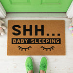 a door mat that says shr baby sleeping
