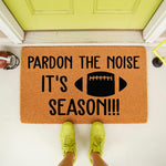 Football season doormat with Pardon The Noise It's Season text and a football graphic, featuring a natural coir fiber welcome mat for front porch decor that is perfect for sports fans and home entrance entryway floor mats.