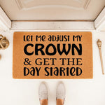 Funny Let Me Adjust My Crown and Get The Day Started doormat featuring bold black text on a natural coir fiber welcome mat, placed at a front door entrance to create a stylish and humorous home decor entryway for guests and