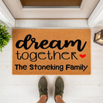 Personalized family name doormat featuring the phrase dream together with a red heart, this custom coir welcome mat is a durable outdoor floor rug for your front porch entry, perfect for housewarming or new home decor for