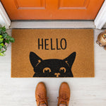 a door mat with a black cat on it