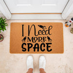 Space themed doormat with rocket ship design and funny I Need More Space text, this natural coir fiber welcome mat is a fun front porch decor piece for science lovers and makes a unique housewarming entry rug for any home