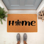 Sea turtle home doormat featuring a black turtle silhouette replacing the letter O in the word home, this natural coir fiber welcome mat is a stylish outdoor floor rug for your front porch entry decor and coastal house entrance.