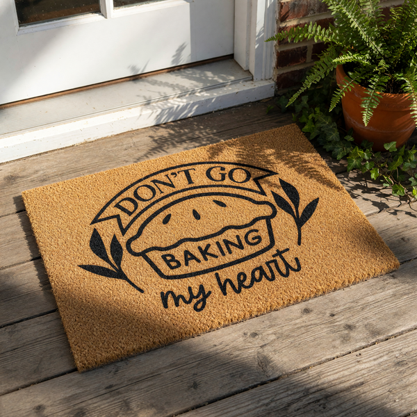 Funny baking doormat with a pie illustration and the text Don't Go Baking My Heart, this natural coir welcome mat is a cute kitchen decor piece for bakers, foodies, and home cooks looking for a unique front porch entry rug.