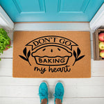 Funny baking themed doormat with a pie illustration and text reading Don't Go Baking My Heart, featuring a natural coir fiber welcome mat design for a kitchen or front porch entrance, perfect for home decor and housewarming gifts.