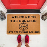 Dungeon master welcome doormat featuring a twenty-sided die graphic and funny gaming text on a natural coir fiber mat, perfect for a front porch entrance to show off your tabletop roleplaying game hobby and love for fantasy board