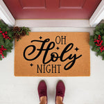 Oh Holy Night Christmas doormat featuring black script text on natural coir fiber, styled with pine greenery and red berries at a front door entrance for a festive holiday home decor look that welcomes guests to your porch.
