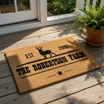 Personalized farm doormat featuring a black deer silhouette and custom family name text on natural coir fiber, this rustic outdoor welcome mat is a durable entrance rug for farmhouse decor, ranch entryways, or housewarming gifts.
