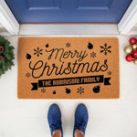 Personalized Merry Christmas doormat for front porch entry, featuring a custom family name banner, festive snowflake and ornament designs on natural coir fiber, creating a stylish holiday welcome mat for your home entrance decor.
