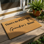 Grandma house doormat with natural coir fiber texture, featuring the printed text There is No Place Like Grandma House in black lettering, making this a durable outdoor welcome mat for a front porch or entryway home decor.