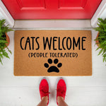 Funny Cats Welcome People Tolerated doormat featuring a black paw print design on natural coir fiber, perfect for a cat lover front porch decor entrance mat that adds a humorous touch to your home entryway and outdoor floor mat