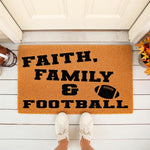 Faith Family and Football doormat featuring a sports theme on a natural coir fiber welcome mat, perfect for a front porch entryway during the fall season with a football graphic and bold black text for a stylish home decor look.