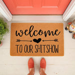 Funny welcome to our shitshow doormat for front porch decor, featuring a natural coir fiber welcome mat with black text and a heart arrow design, perfect for a humorous housewarming entry rug or a sarcastic home entrance floor