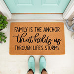 Family Is The Anchor doormat featuring nautical decor, this natural coir welcome mat has black text reading Family Is The Anchor that holds us through life's storms, perfect for a front porch entry or a coastal home decor style.