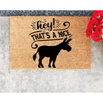 Funny donkey doormat with a natural coir fiber texture, featuring a black silhouette of a donkey and the text Hey That's A Nice Donkey, making this a humorous welcome mat for your front porch or entryway decor.