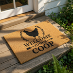 Chicken coop welcome doormat featuring a black hen silhouette and farmhouse style text that reads Welcome To Our Coop, this natural fiber coir welcome mat is a funny farm decor piece for your front porch or entryway floor.