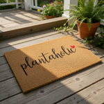 Plantholic coir doormat with a cute red heart design, featuring natural fiber construction for a durable outdoor welcome mat that is perfect for any plant lover home entrance or front porch decor for houseplant enthusiasts.