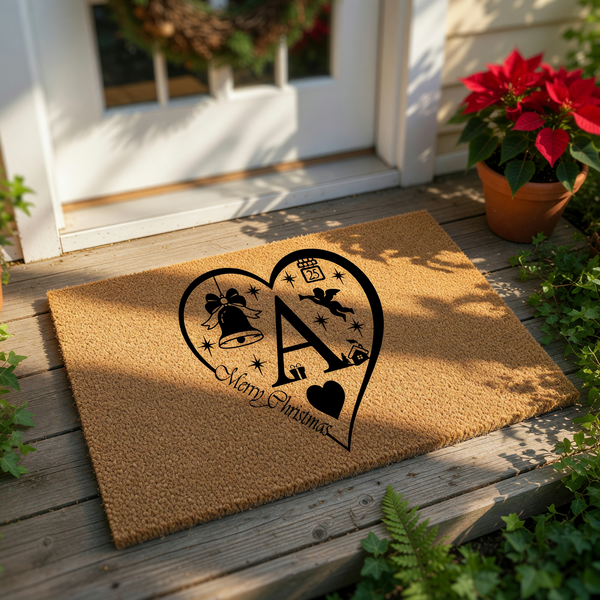Personalized Christmas doormat featuring a large heart design with a central letter, holiday bell, and angel icon on natural coir fiber, making a festive front porch welcome mat for the winter holiday season and home decor.