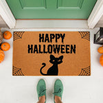 Happy Halloween black cat doormat featuring a spooky dripping font and spider web corners on natural coir fiber, perfect for fall porch decor and seasonal entryway floor mats to welcome guests during the autumn holiday season.