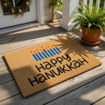 A mat with the text "Happy Hanukkah" printed on it, along with a graphic of lit candles.