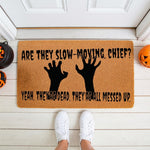 Funny Halloween doormat featuring zombie hands and a spooky quote on natural coir fiber, perfect for a front porch welcome mat.