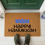 a happy hanukkah mat with candles on it