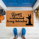 Funny Halloween doormat with zombie hand graphic and text reading Dead Welcomed Living Tolerated, this natural coir welcome mat is a spooky front porch decor piece for fall home entryways and seasonal outdoor floor mat